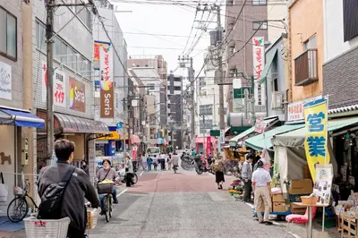 a street in an asian city with people walking around at Tokyo Kitaku hotel in Tokyo