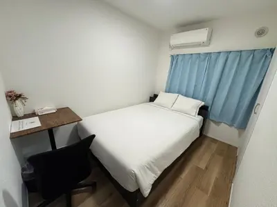 a small room with a bed and a desk and a window at 2 bedrooms entire house in Tokyo