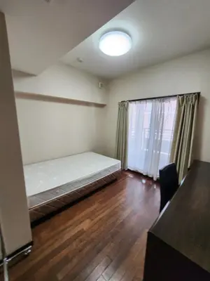 an empty room with a bed and a window at LiVEMAX Claudia Akasakamitsuke in Tokyo