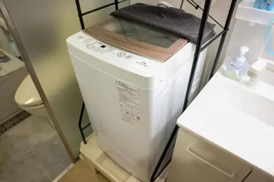a washer and dryer sitting on a shelf in a kitchen at Toudaimae Mukougaoka Corpo #MTM in Tokyo