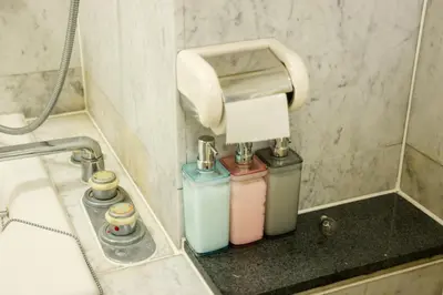 a bathroom with a soap dispenser and two bottles at Toudaimae Mukougaoka Corpo #MTM in Tokyo