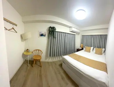 a hotel room with a bed and a table at miyabi I - \u96c5 I in Tokyo