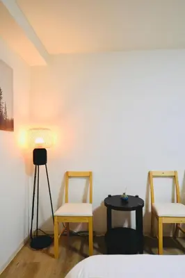 a room with two chairs and a table with a lamp at miyabi 3 - \u96c5 3 in Tokyo