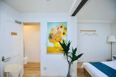 a bedroom with a painting of flowers on the wall at miyabi 4 - \u96c5 4 in Tokyo