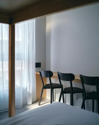 two chairs sitting in a room with a table at da Haus Shinjuku in Tokyo