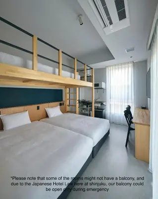 a bedroom with a bunk bed and a desk at da Haus Shinjuku in Tokyo