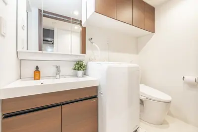 a white bathroom with a sink and a toilet at Dash Living Ueno Park in Tokyo