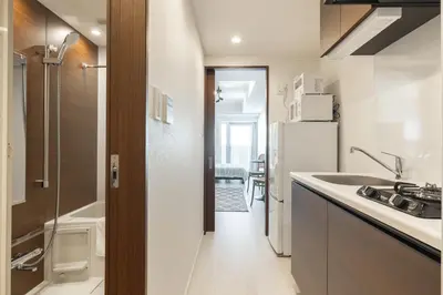 a small kitchen with a sink and a refrigerator at Dash Living Ueno Park in Tokyo
