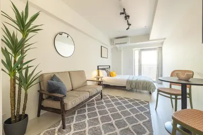 a living room with a couch and a bed at Dash Living Ueno Park in Tokyo