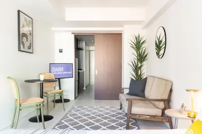 a living room with a couch and chairs and a table at Dash Living Ueno Park in Tokyo