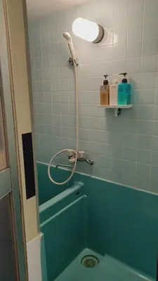 a bathroom with a blue tub and a shower at 2nd house in Tokyo