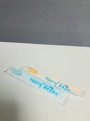 a plastic toothbrush sitting on top of a counter at 2nd house in Tokyo