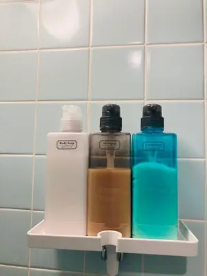 three bottles sitting on a shelf in a bathroom at 2nd house in Tokyo