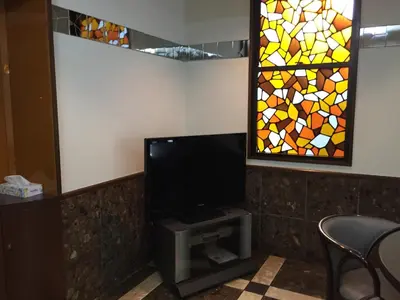a flat screen tv with a stained glass window at \u30a2\u30fc\u30d0\u30f3\u30db\u30c6\u30eb\u68ee\u4e0b in Tokyo