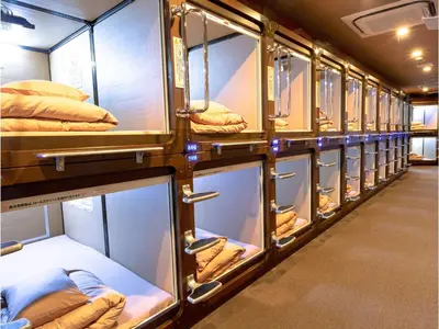 a row of bunk beds in a train at Anshin oyado Tokyo Man Ginza Shimbashi Station in Tokyo