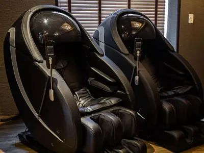 two black leather seats in a room at Anshin oyado Tokyo Man Ginza Shimbashi Station in Tokyo