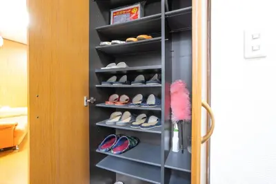 a closet with a bunch of shoes in it at 7House in Tokyo