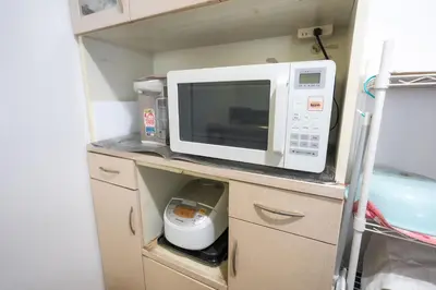 a microwave oven sitting on top of a kitchen counter at 7House in Tokyo