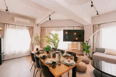 a living room with a long table and chairs at Eminaz Minami Otsuka 2F in Tokyo