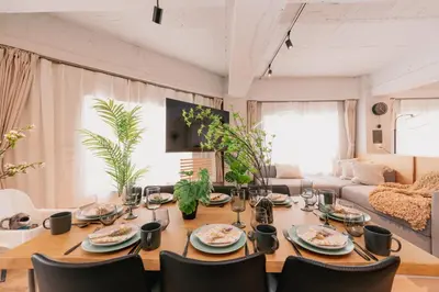 a dining room table and chairs in a living room at Eminaz Minami Otsuka 2F in Tokyo
