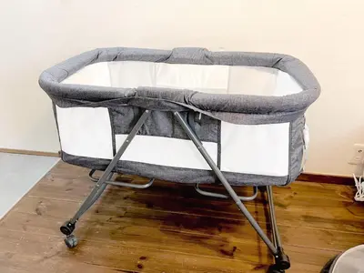 a gray and white baby stroller sitting on a wooden floor at Eminaz Minami Otsuka 3F4F in Tokyo