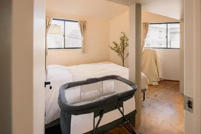 a small bedroom with a bed and a chair at Eminaz Minami Otsuka 3F4F in Tokyo