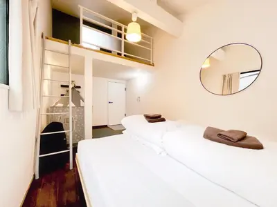 two beds in a room with a mirror at Eminaz Minami Otsuka 3F4F in Tokyo
