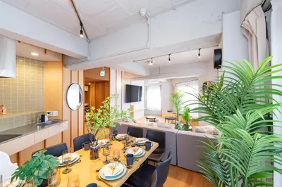 a dining room with a table and a couch at Eminaz Minami Otsuka 3F4F in Tokyo