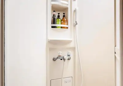 a white refrigerator with drinks in a cabinet at 101 Shinjuku Modern Apartment Triple Station Access Free Wi-Fi in Tokyo