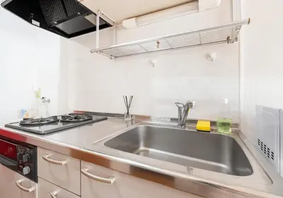 a kitchen with a sink and a stove at 101 Shinjuku Modern Apartment Triple Station Access Free Wi-Fi in Tokyo