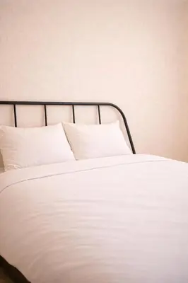 a white bed with white sheets and pillows at 101 Shinjuku Modern Apartment Triple Station Access Free Wi-Fi in Tokyo