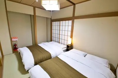 two beds in a small room with at \u6885\u5c4b\u6577\u8cb8\u5bb6 in Tokyo