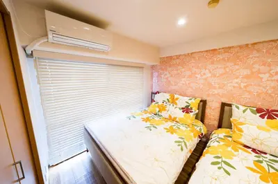 a bedroom with two beds and a window at Shibuya sta 3min\u30fbcenter area\u30fbSwitch\u30fbPocket Wi-Fi in Tokyo