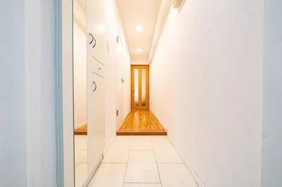 a hallway with white walls and a wooden door at Shibuya sta 3min\u30fbcenter area\u30fbSwitch\u30fbPocket Wi-Fi in Tokyo