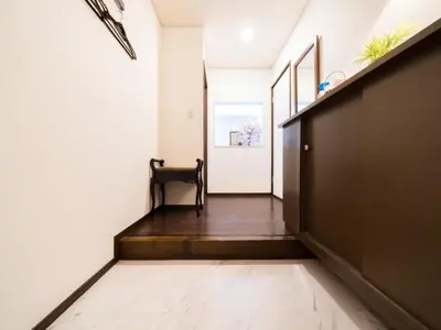 a hallway with a door and a bench in a room at Shinjuku-Okubo sta, 3 min walk-Switch-Movie-Internet-Mobile Wi-Fi in Tokyo