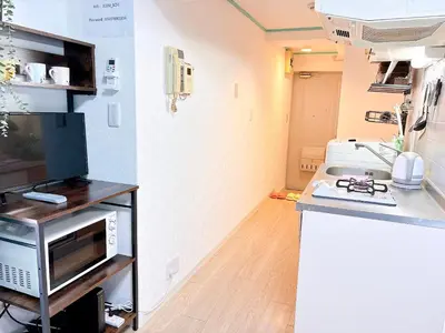 a kitchen with a microwave and a counter top at 403, Shinjuku City, JR Yamanote Line, 6 min walk to stn in Tokyo
