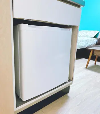 a small white refrigerator in a room at 403, Shinjuku City, JR Yamanote Line, 6 min walk to stn in Tokyo