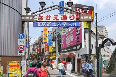 a busy city street with people walking down the street at 403, Shinjuku City, JR Yamanote Line, 6 min walk to stn in Tokyo