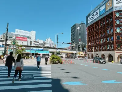 a group of people walking across a crosswalk in a city at 403, Shinjuku City, JR Yamanote Line, 6 min walk to stn in Tokyo