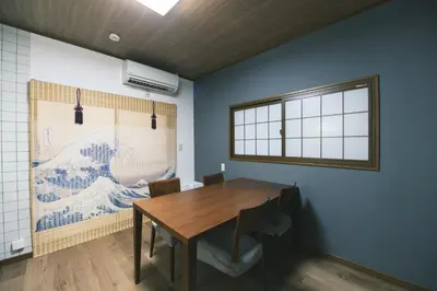 a dining room with a wooden table and a window at Ukiyoan Kachofugetsu in Tokyo