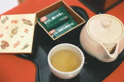 a cup of tea sitting next to a tea pot at Ukiyoan Kachofugetsu in Tokyo