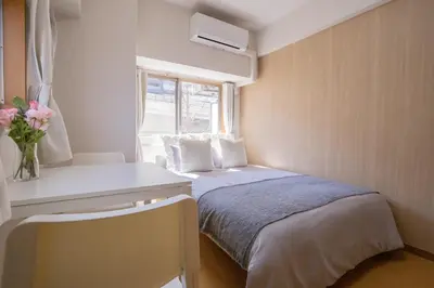 a small bedroom with a bed and a window at walk to JR Shibuya sta.-SoE4 in Tokyo