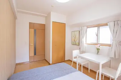 a bedroom with a bed and a table and a window at walk to JR Shibuya sta.-SoE4 in Tokyo