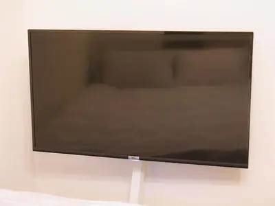 a flat screen tv hanging on a wall at Lucky Yotsugi - \u30e9\u30c3\u30ad\u30fc\u56db\u30c4\u6728 in Tokyo
