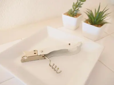 a knife on a white counter with two potted plants at Lucky Yotsugi - \u30e9\u30c3\u30ad\u30fc\u56db\u30c4\u6728 in Tokyo