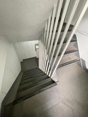 a staircase in a building with a metal railing at Lucky Horikiri - \u30e9\u30c3\u30ad\u30fc\u5800\u5207 in Tokyo