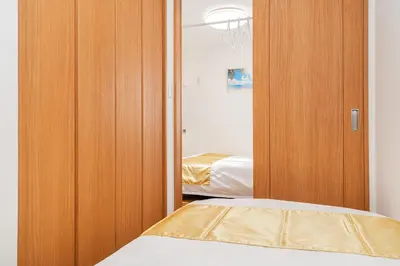 a bedroom with a wooden closet and a bed at KYARA HOTEL\u3000\u4e80\u6238502 in Tokyo