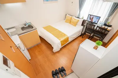 a small room with a bed and a small kitchen at KYARA HOTEL\u3000\u4e80\u6238502 in Tokyo