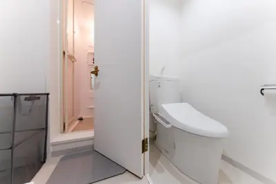 a white bathroom with a toilet and a shower at SAKURA Residence\u76ee\u9ed2\u99c5\u524d Junior Suite in Tokyo