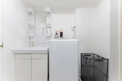 a white bathroom with a sink and a mirror at SAKURA Residence\u76ee\u9ed2\u99c5\u524d Junior Suite in Tokyo